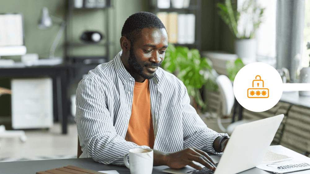 Person sending email from a laptop in an office, illustrating mass email in Gmail